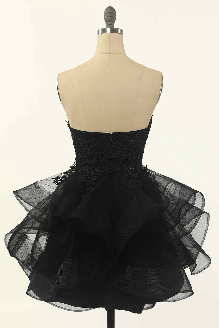 Side view of A-line strapless V-neck homecoming dress with flowing multi-layer skirt.