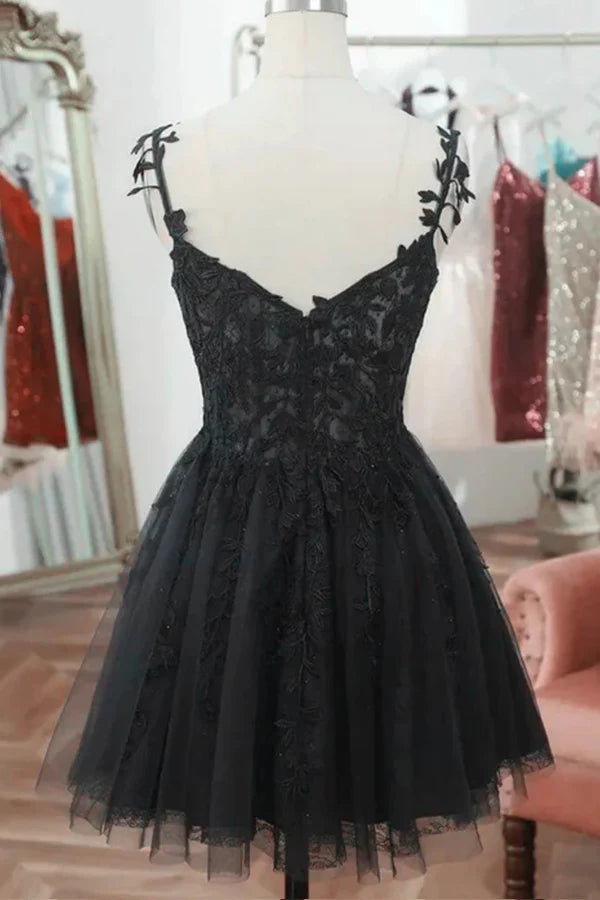 Close-up of lace detail on a black sweetheart homecoming dress.