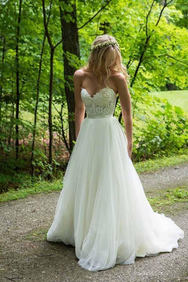 A-line ivory wedding dress with sweetheart neckline and lace applique.