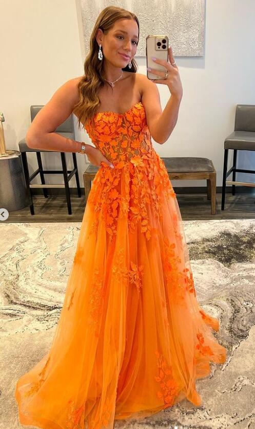 Elegant orange A-line prom dress with sweetheart neckline and lace appliques.