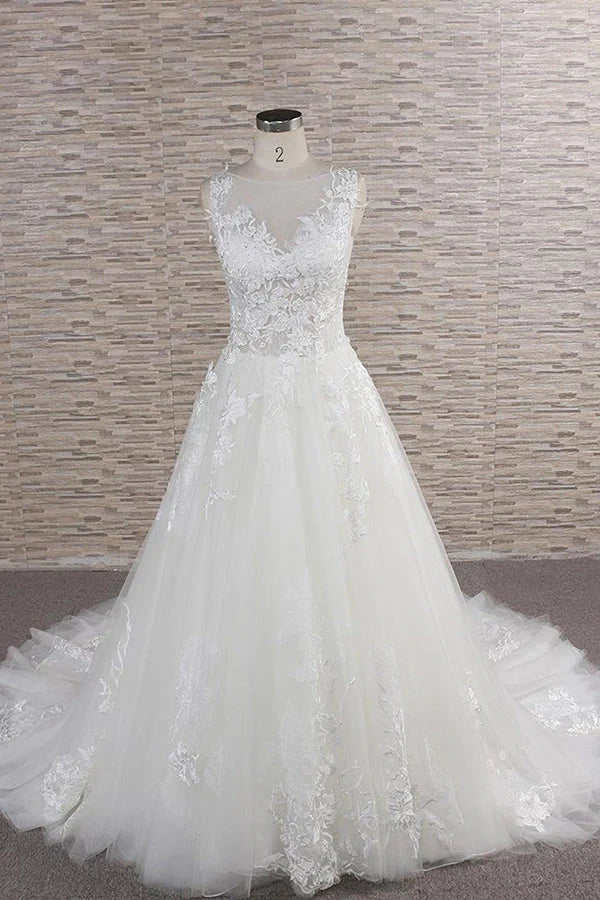 Elegant A-line sweetheart wedding dress with lace appliques and flowing tulle skirt.