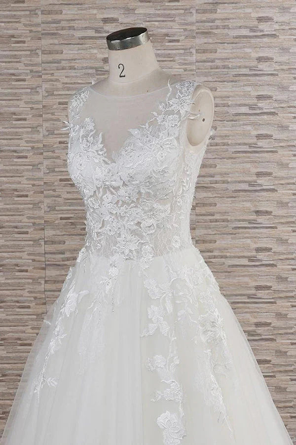 Close-up of intricate lace appliques on the sweetheart bodice of the bridal dress.