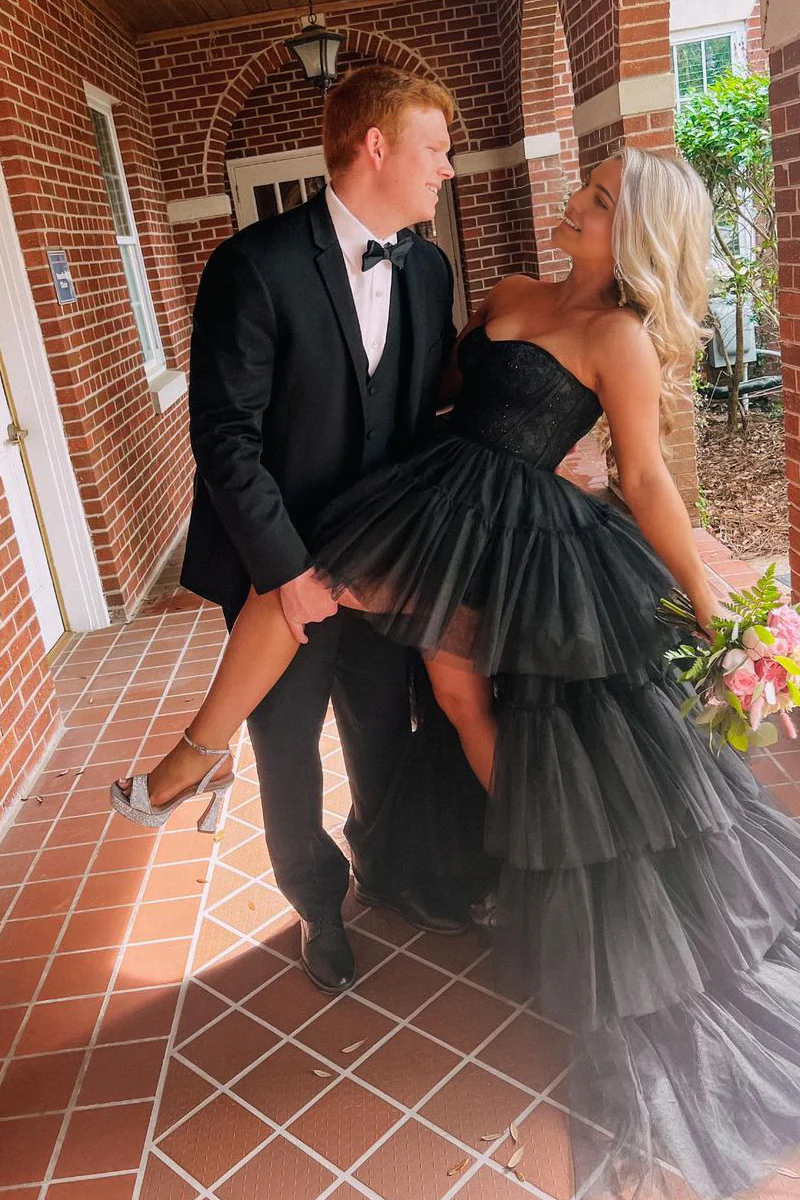Close-up of the sweetheart neckline and lace embellishments on the black tulle dress.