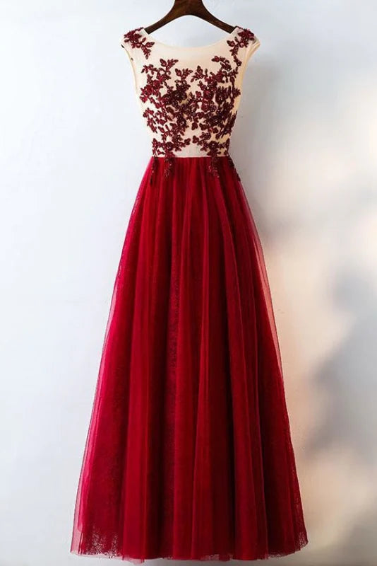 Full view of an elegant A-line lace applique tulle long prom dress in blush.