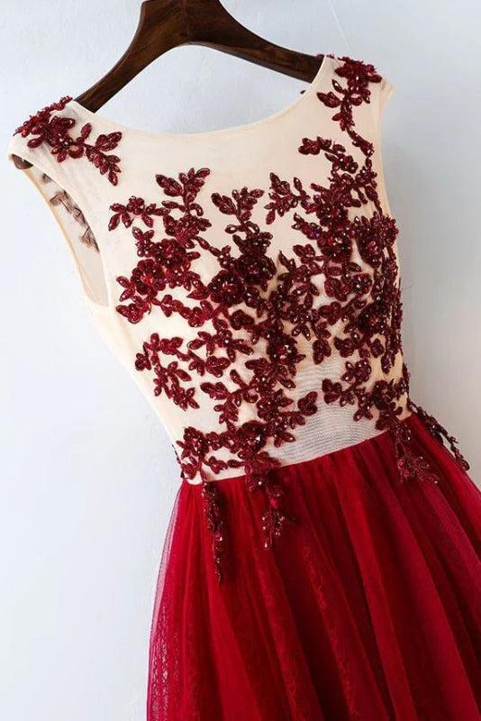 Close-up of the intricate lace applique details on the bodice of the blush tulle prom dress.