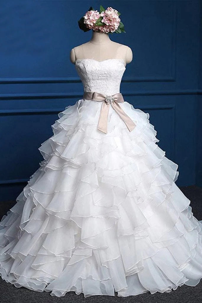 Elegant A-line white wedding dress with sweetheart lace top and flowing chiffon skirt.