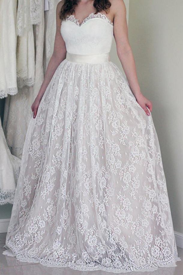 Elegant A-line strapless wedding dress with sweetheart lace neckline and flowing skirt.