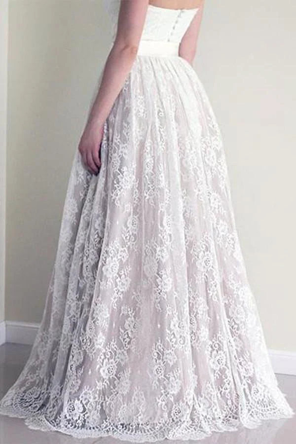 Close-up of the delicate lace detailing on the sweetheart neckline of the bridal gown.