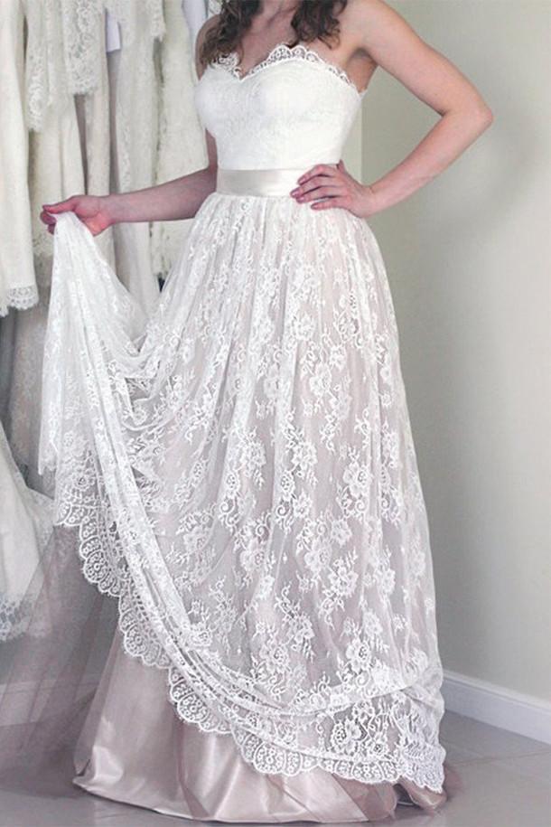 Romantic A-line wedding dress featuring a strapless sweetheart design and elegant lace accents.