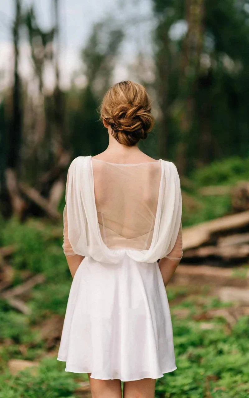 Side profile of the A-line wedding gown, highlighting the sweetheart neckline and long illusion sleeves.