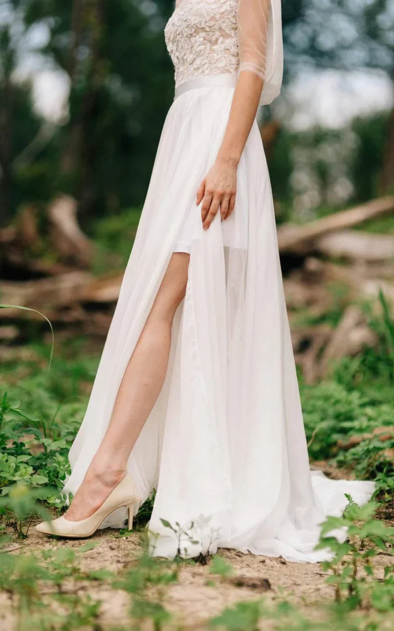 Detailed view of the sweetheart neckline and delicate lace appliqué on the bridal gown.