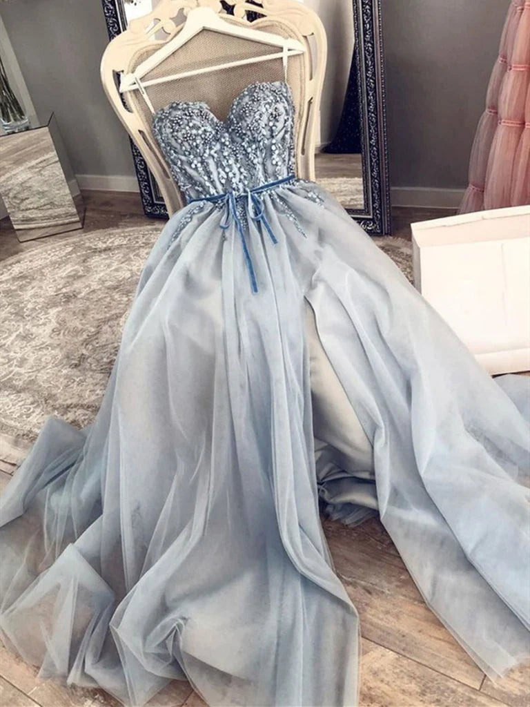Woman wearing an A-line sweetheart neck beaded long formal prom dress.