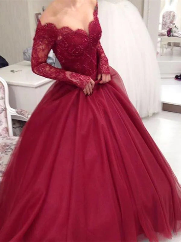 Woman wearing an A-line sweetheart neck long sleeve lace prom dress.