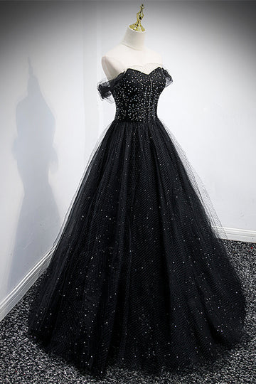 Close-up of the beaded detailing on the bodice of the off-the-shoulder tulle dress.