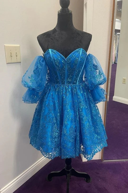 Model wearing an A-line sweetheart short homecoming dress with puff sleeves.