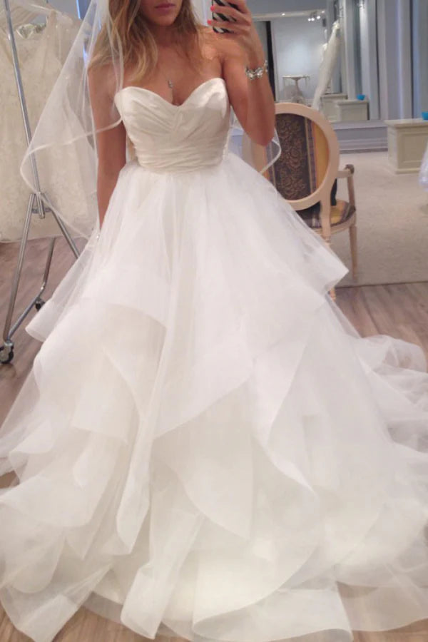 Elegant A-line satin ball gown with sweetheart neckline and ruffled organza skirt.