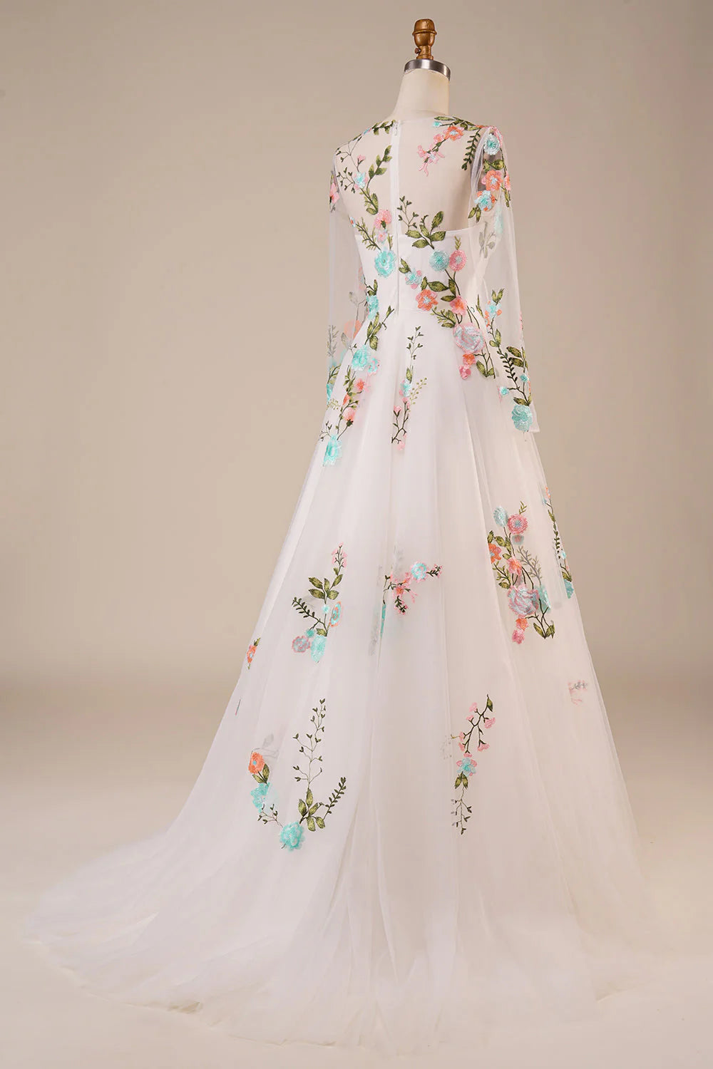 Back view of an ivory wedding gown featuring delicate embroidery and flowing tulle.