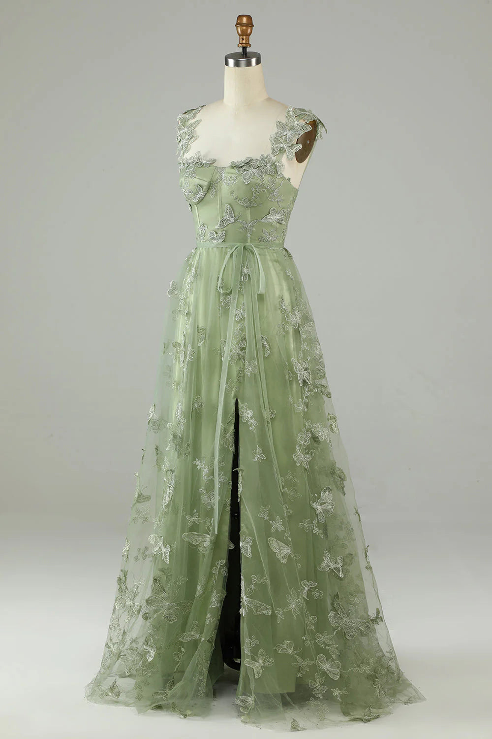 Flowing green tulle gown with intricate 3D butterflies, side view.