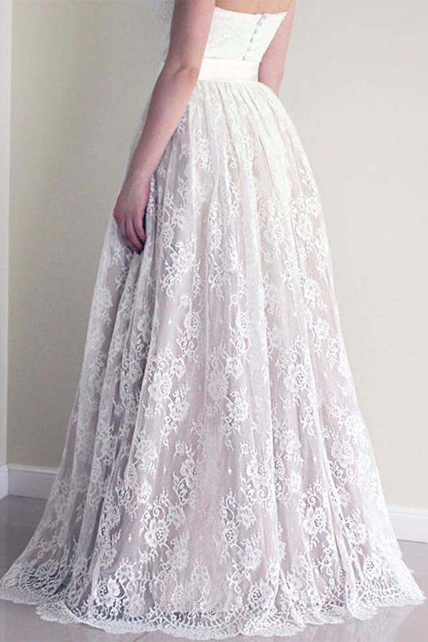 Close-up of the lace detail on the white wedding dress.