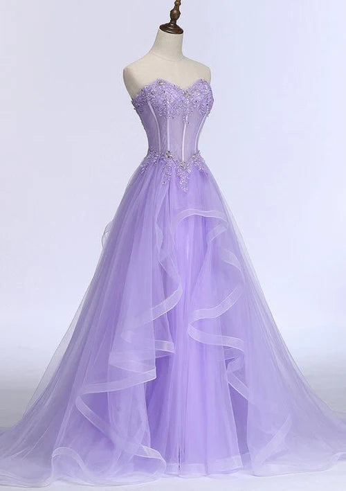 A-line sweetheart sleeveless tulle prom dress with intricate appliqués and beading.