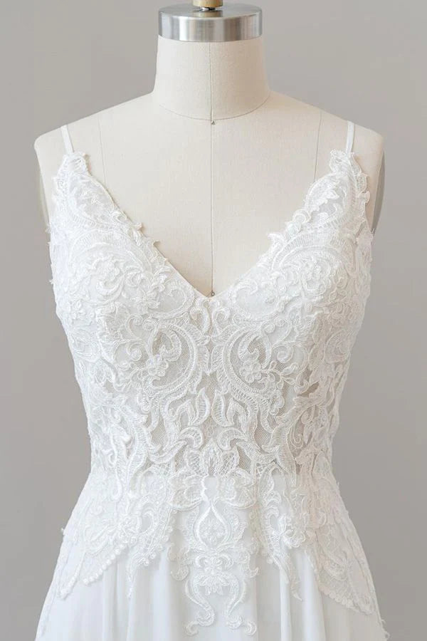 Close-up of intricate appliques on sweetheart neckline wedding dress.