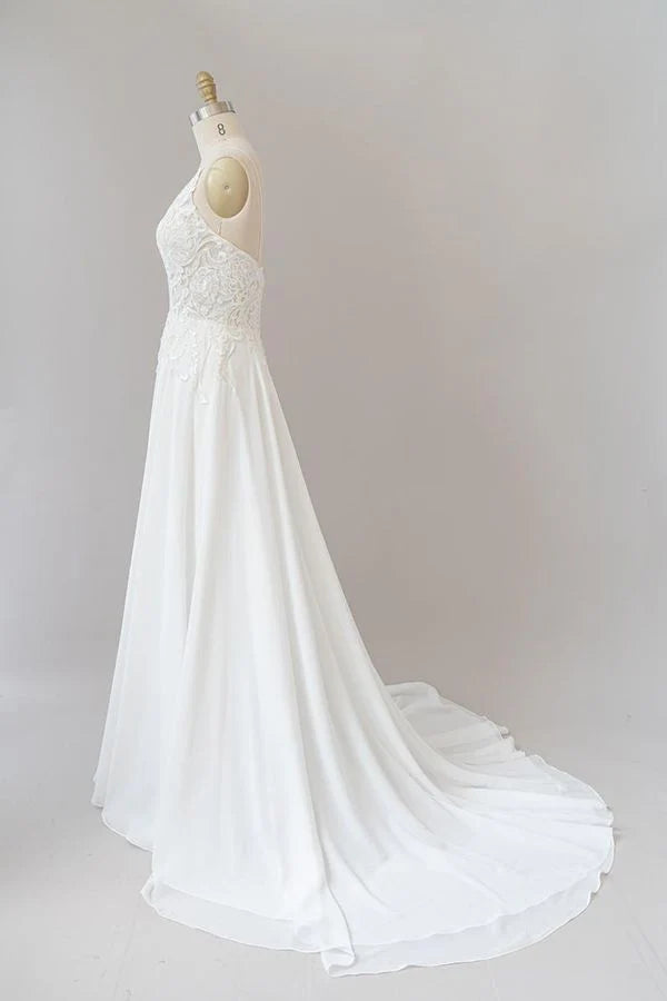 Side view of long A-line wedding dress with flowing chiffon skirt.