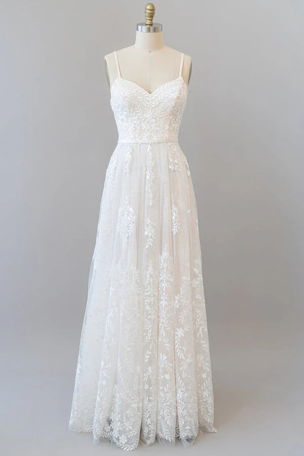 A-line sweetheart wedding dress with spaghetti straps and appliques.