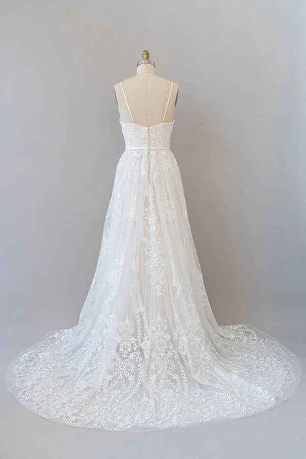 Back view of a long tulle wedding dress with delicate appliques.