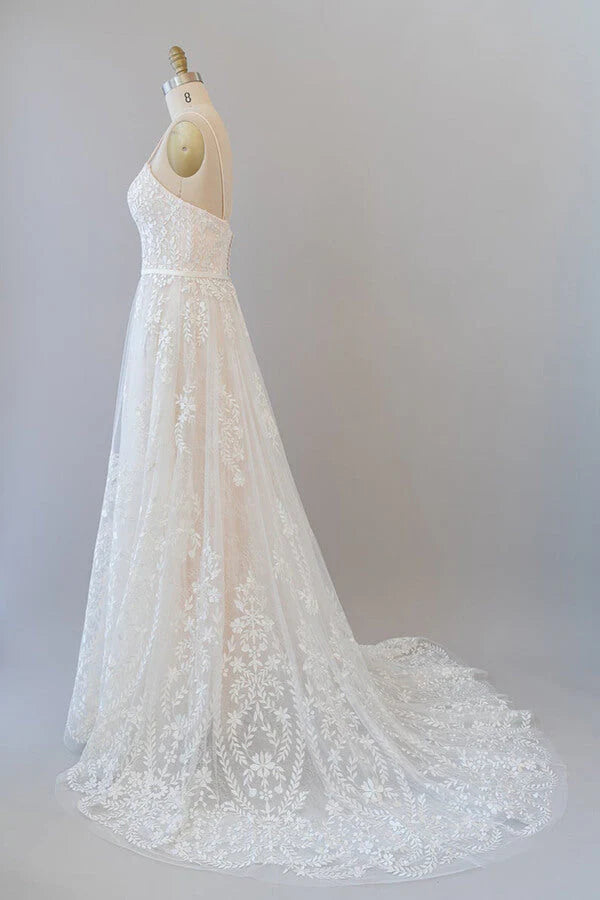 Side view of an A-line bridal gown with spaghetti straps.