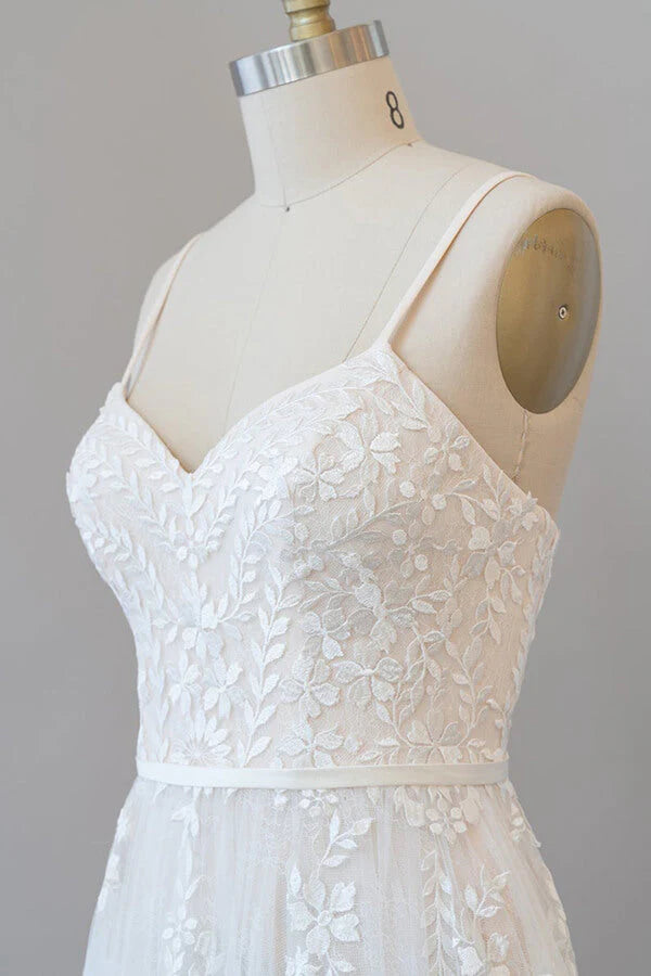 Full length view of a bride wearing an elegant tulle wedding dress.
