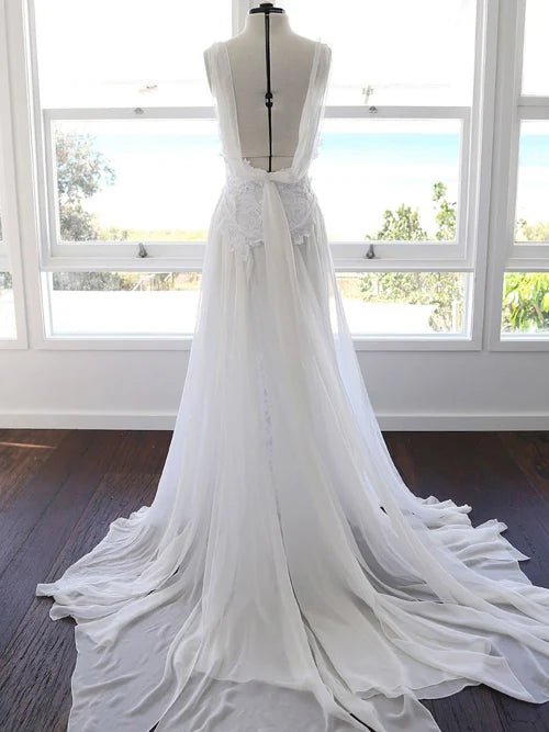 Back view of a flowing A-line chiffon beach wedding dress with delicate lace details.