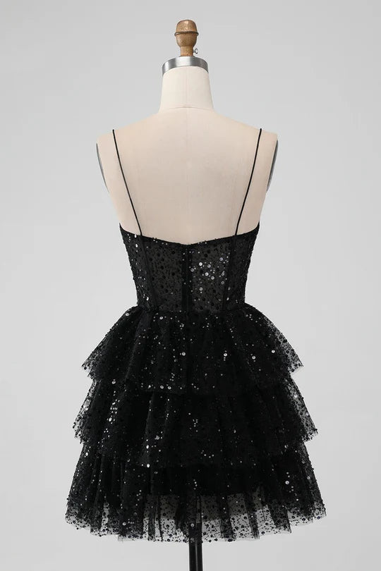 Back view of a model in a spaghetti strap tulle homecoming dress.