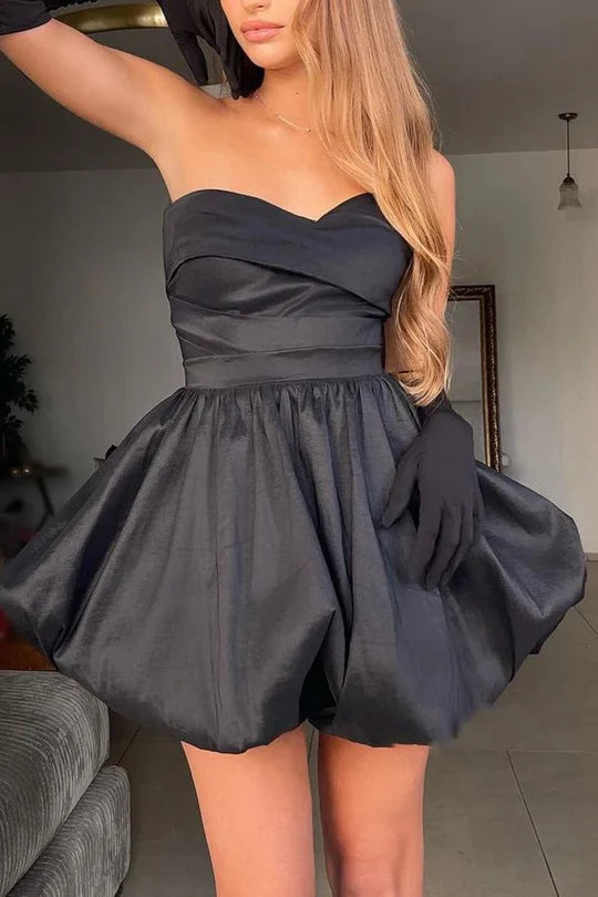Front view of a black A-line sweetheart strapless satin homecoming dress with lace-up back.