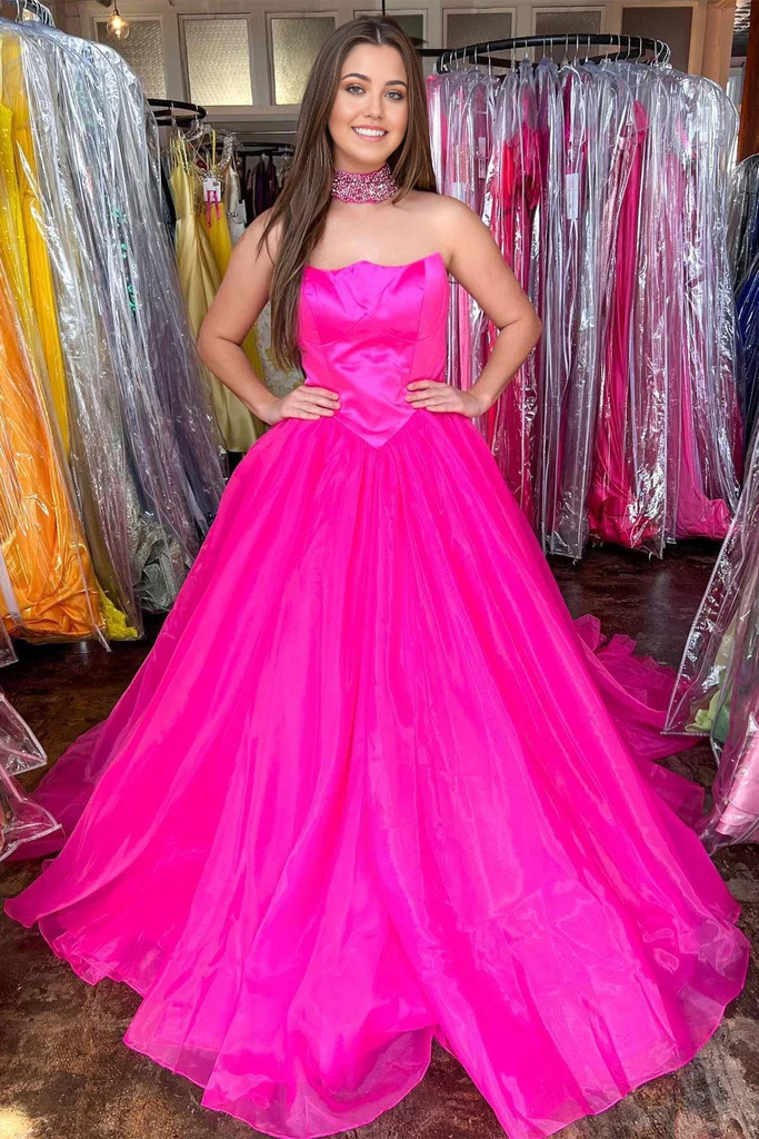Hot pink A-line strapless tulle prom dress.