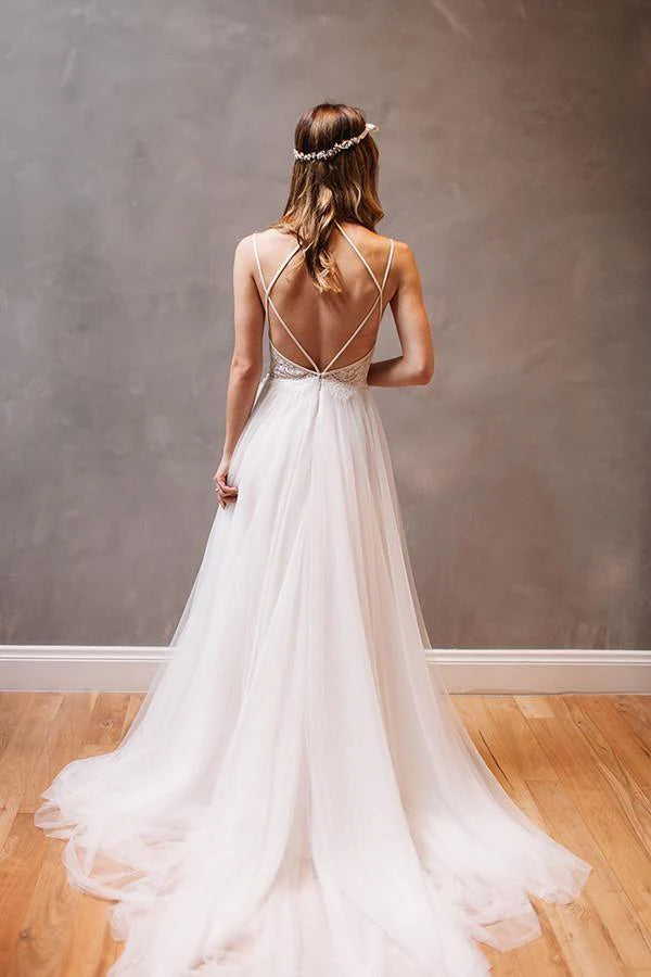 Close-up of beading on the bodice of a white chiffon wedding dress.