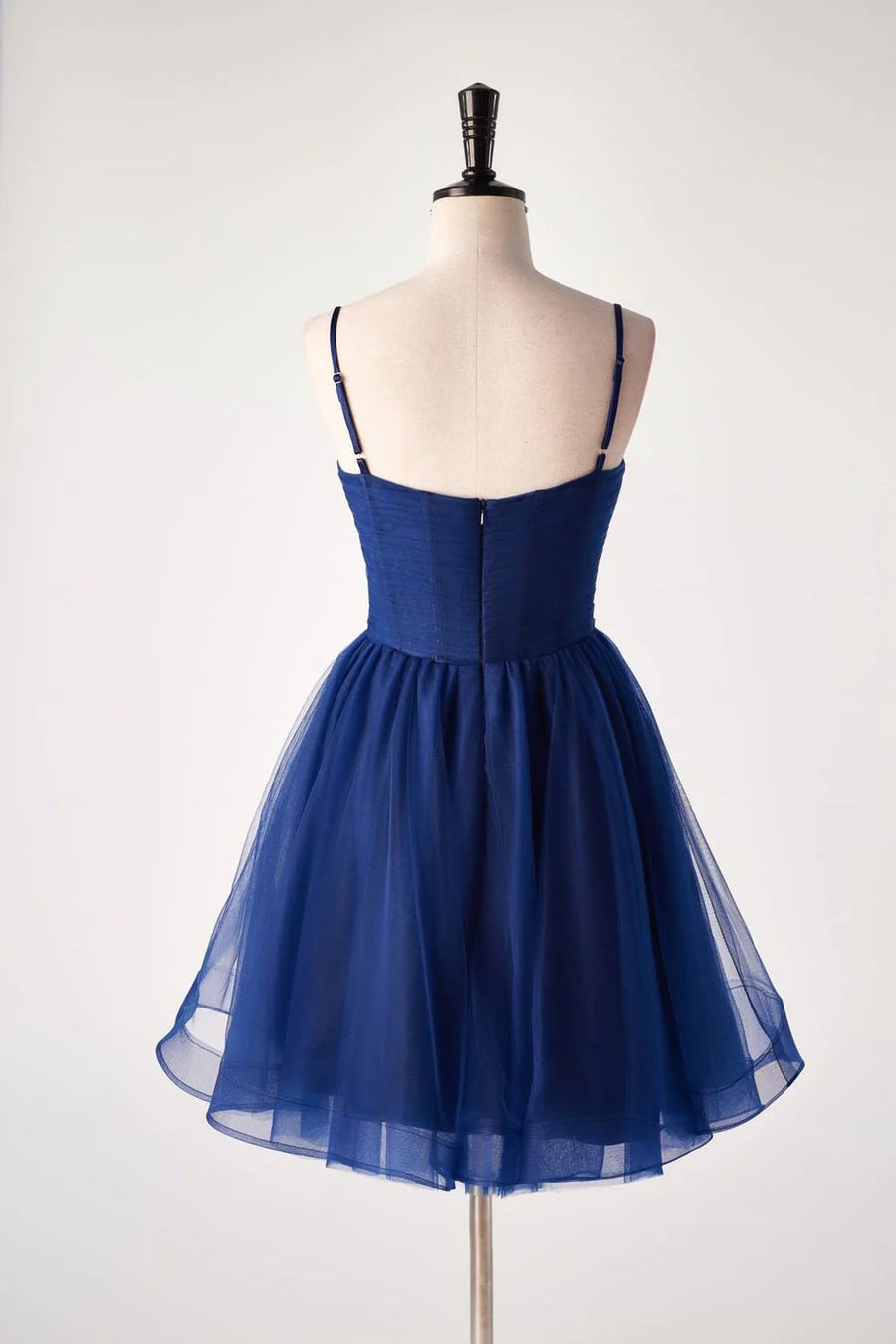 Back view of a woman wearing an A-line sweetheart homecoming dress.