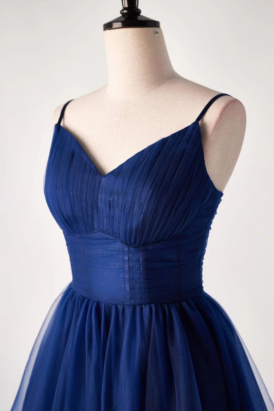 Side view of a woman in a tulle applique homecoming dress.