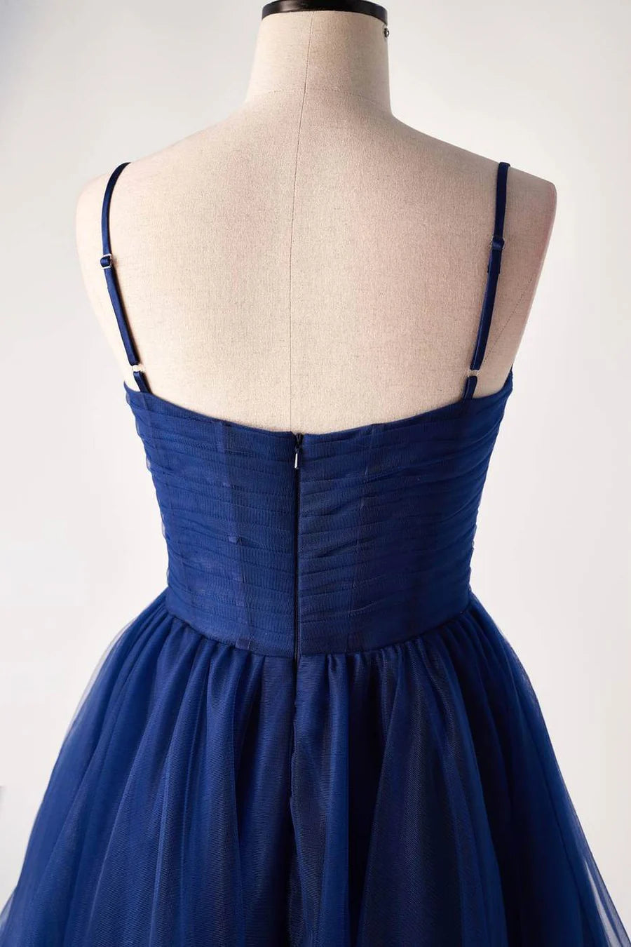 Detailed view of the sweetheart neckline and straps on a homecoming dress.