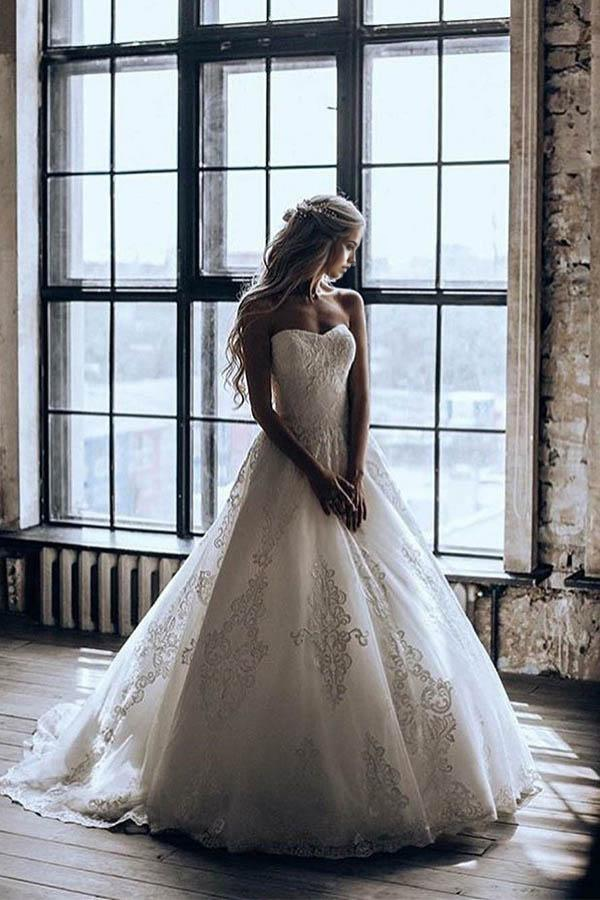 Elegant A-line sweetheart ball gown wedding dress with appliques and sweep train.