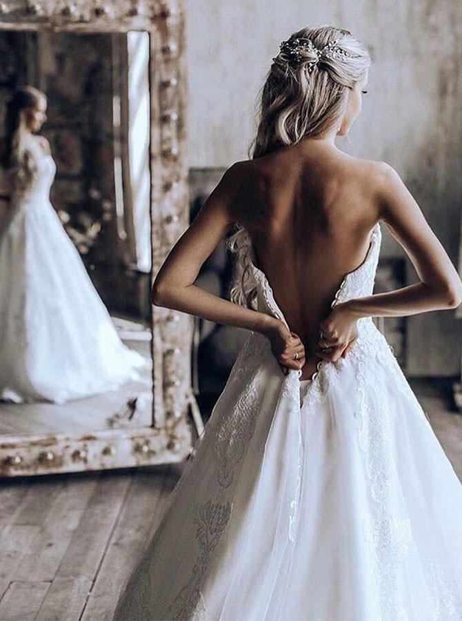 Back view of the A-line tulle wedding dress showcasing the sweep train.