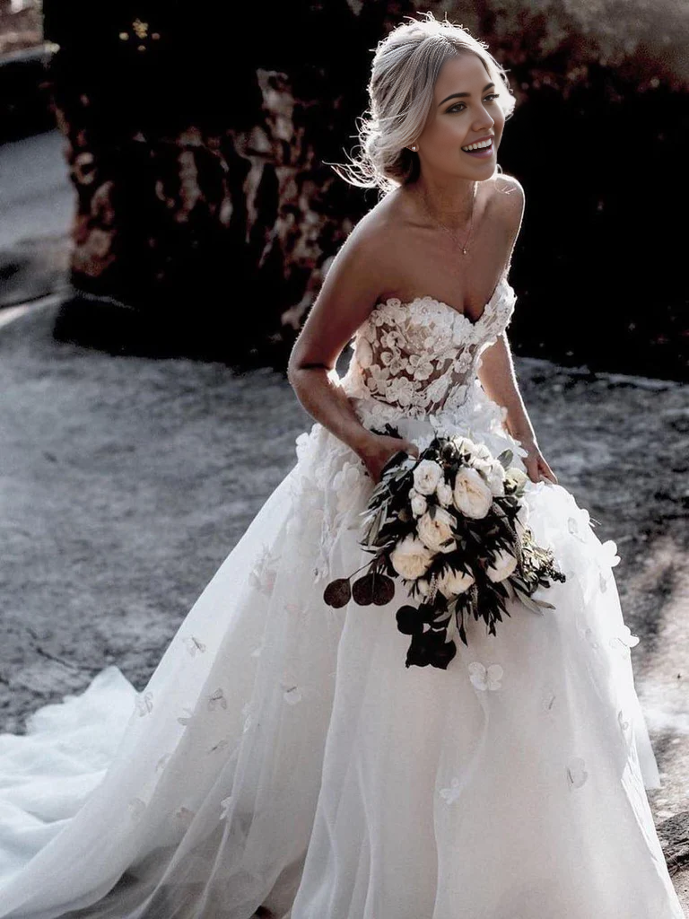 Full view of an elegant A-line sweetheart tulle appliqued wedding gown.