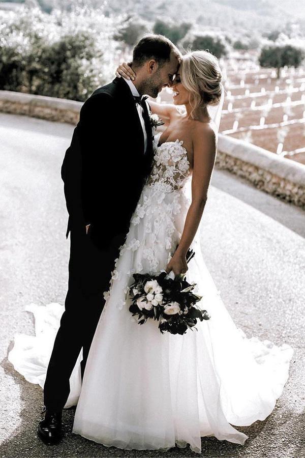 Close-up of the intricate appliqued details on the sweetheart wedding dress.