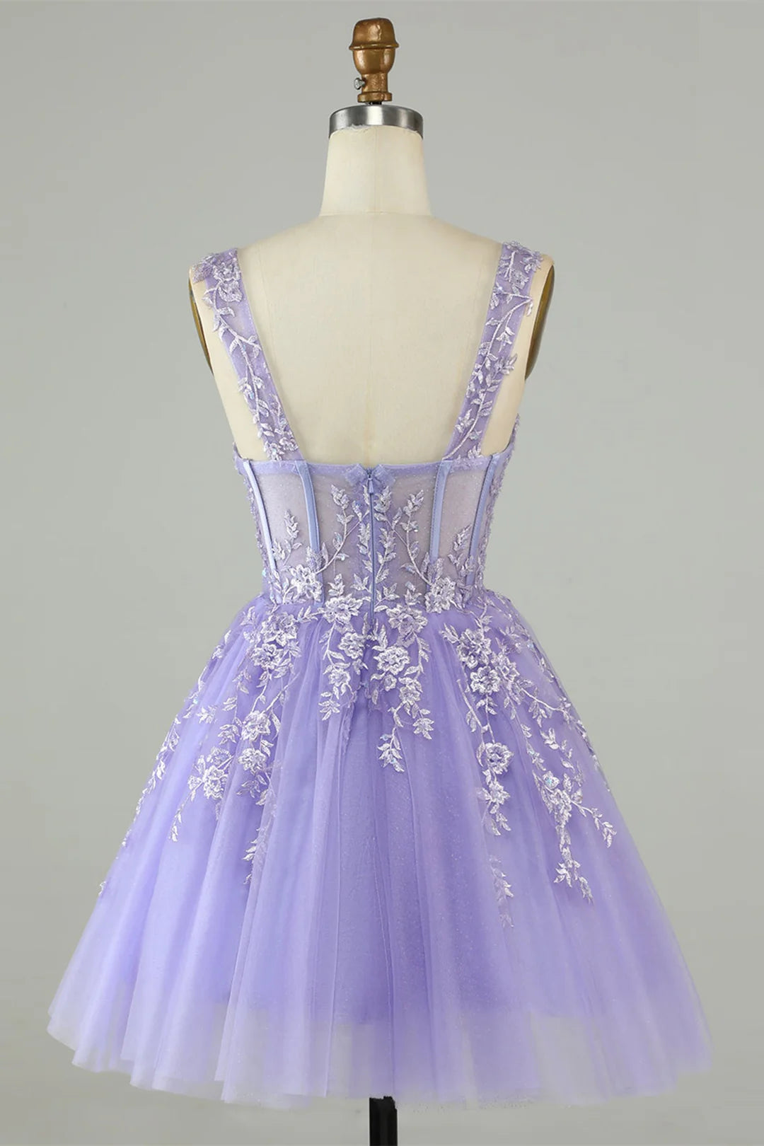 Close-up of the delicate appliques on the tulle fabric of the dress.