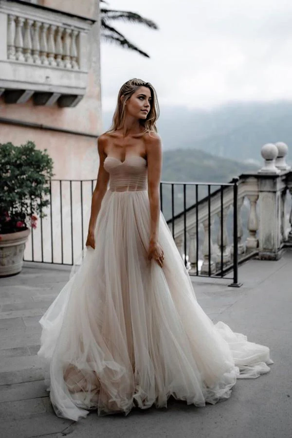 Elegant A-line wedding dress with sweetheart neckline and flowing tulle skirt.