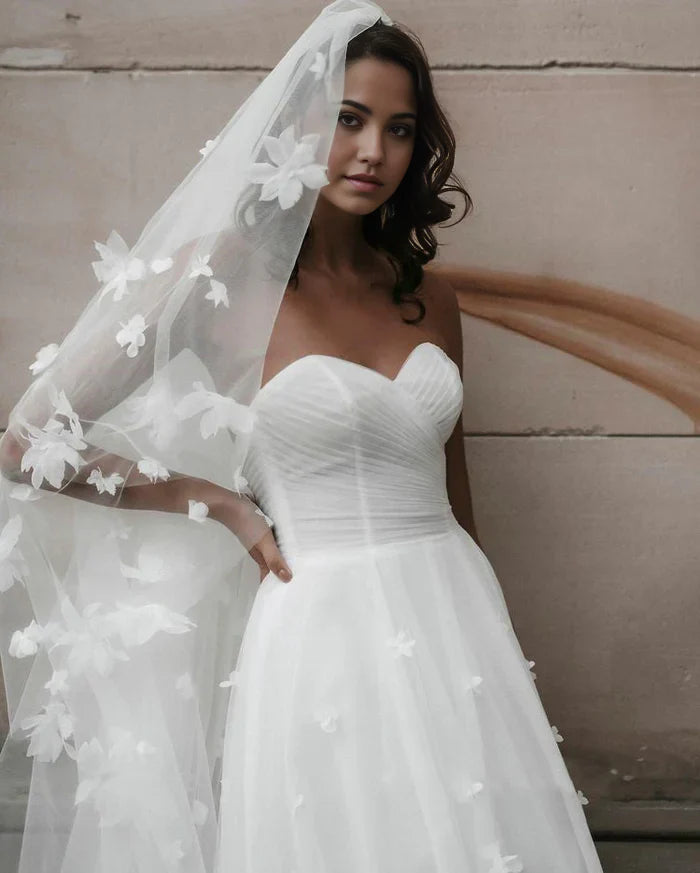 Close-up of the delicate floral details on the tulle wedding dress.