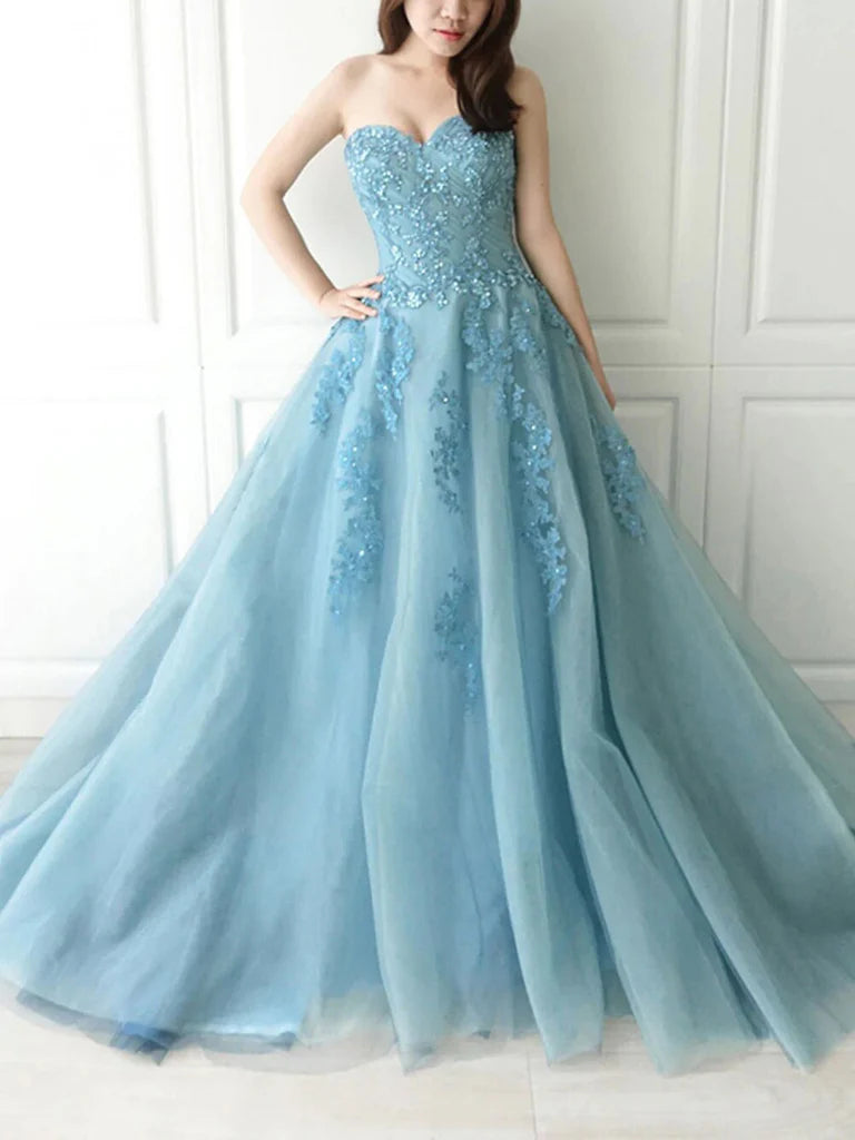 Woman wearing an elegant A-line sweetheart tulle lace long prom gown.