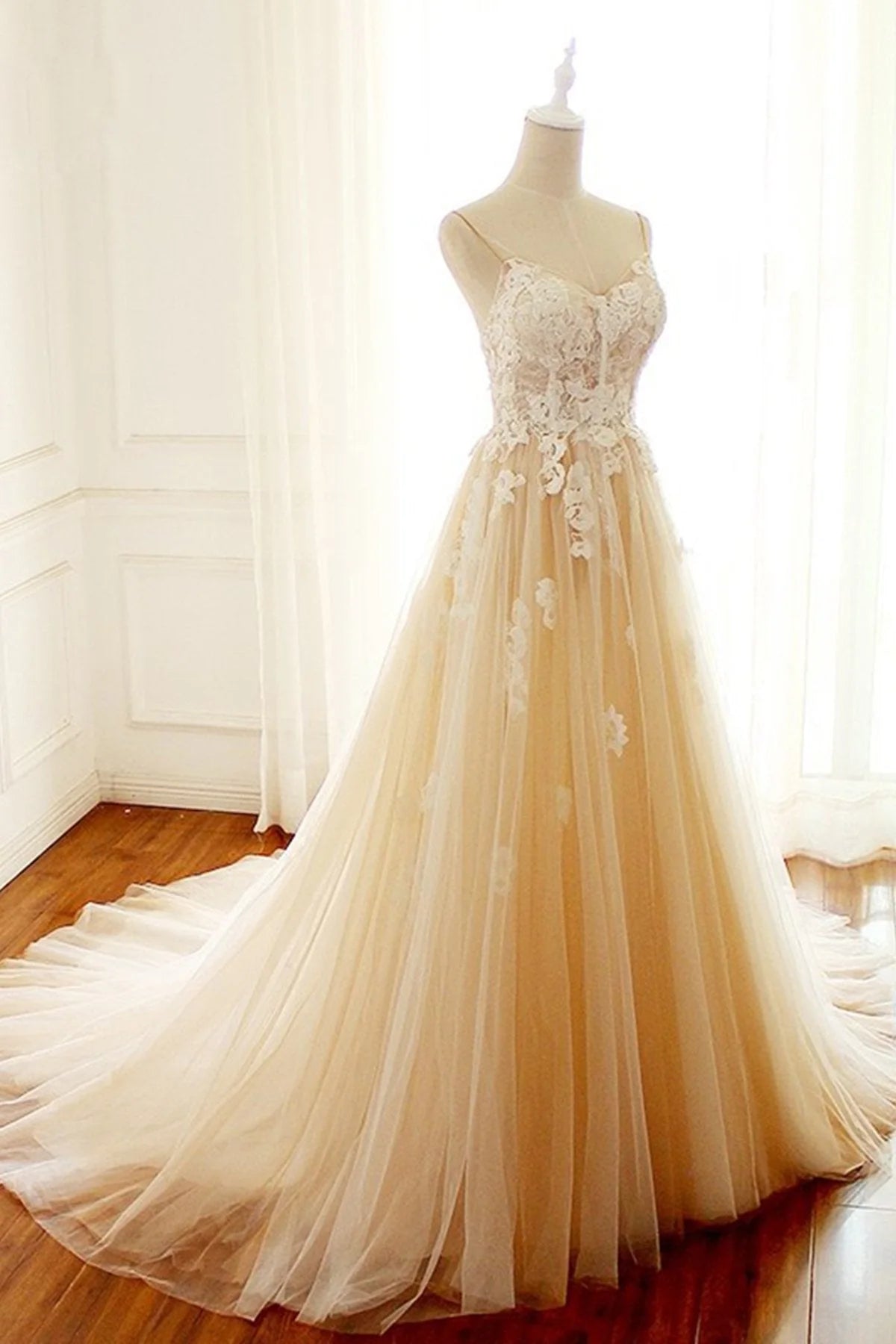 Elegant A-line wedding dress with sweetheart neckline and spaghetti straps.