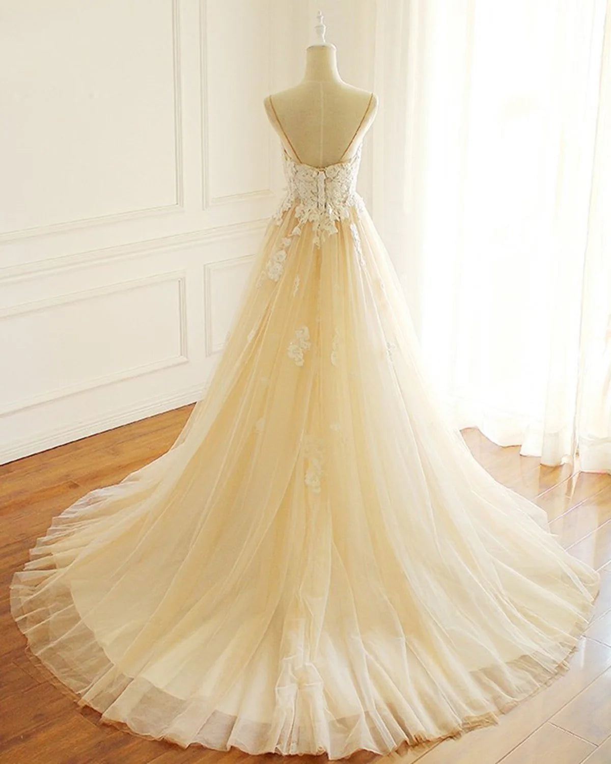 Back view of A-line tulle wedding gown with sweep train.