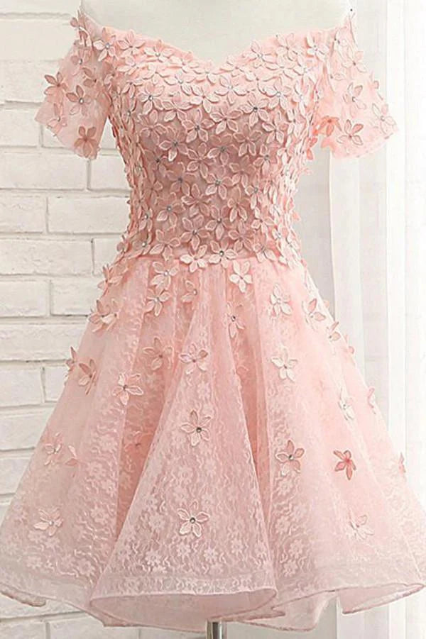 Model in an A-line tulle off-shoulder homecoming dress with floral appliques.