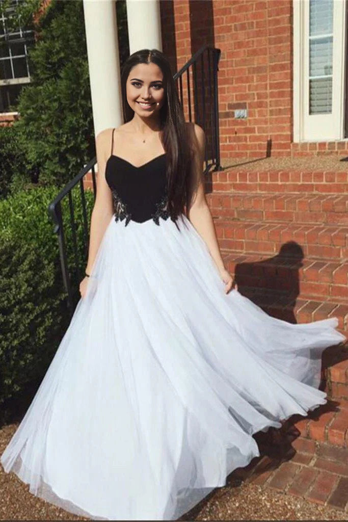 Elegant A-line tulle prom dress with spaghetti straps.
